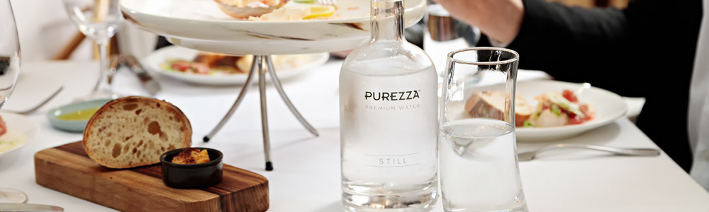 Purezza still water served in re-usable glass purezza bottles